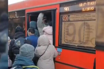 Дети и взрослые подолгу стоят на остановке и мерзнут в ожидании общественного транспорта.